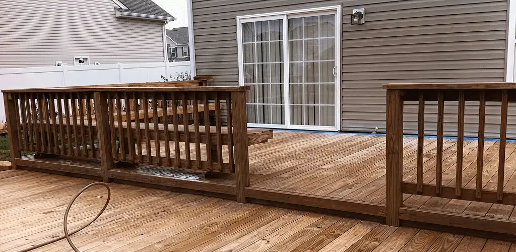 Deck sealing service protecting a backyard wood deck and railings in Kansas City, KS