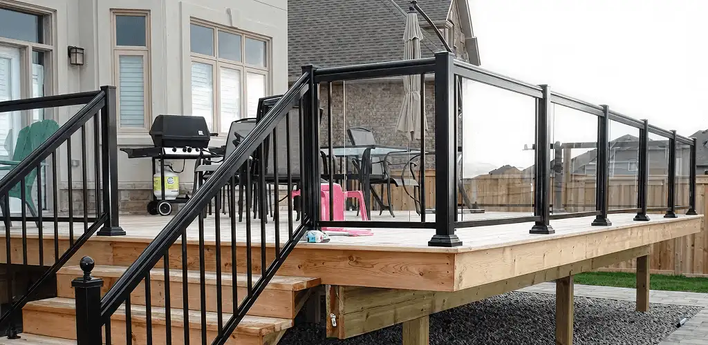 Handrail installation on a deck staircase for safety and code compliance in Kansas City, KS