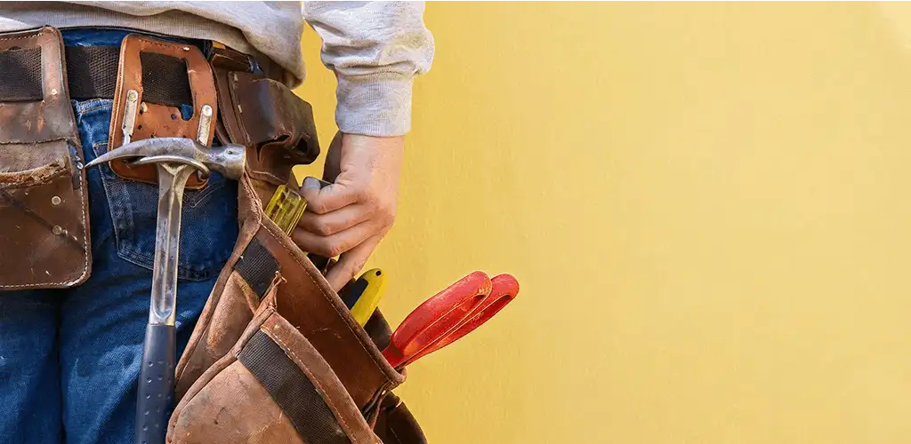 Handyman with tool belt ready for home repairs and maintenance in Kansas City, KS