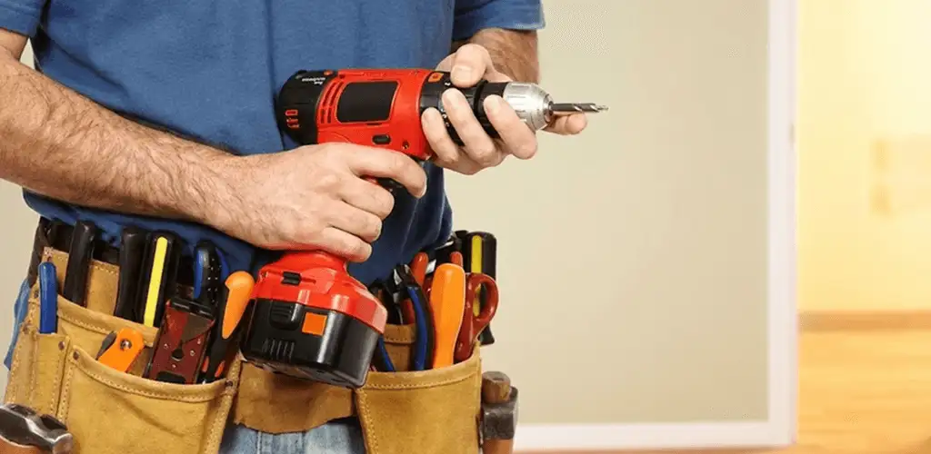 Handyman holding a power drill for home repairs and installations in Kansas City, KS