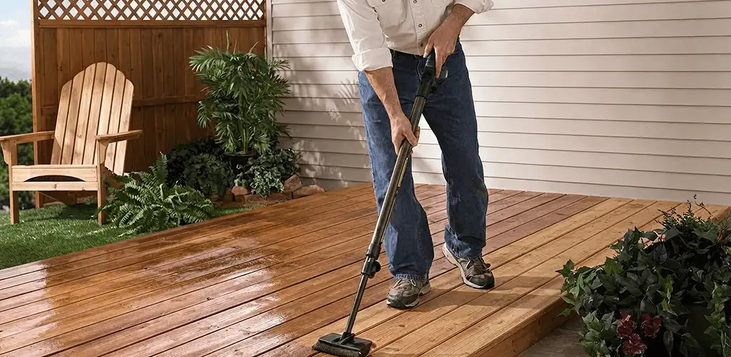 Deck staining service applying stain to a backyard wood deck in Kansas City, KS